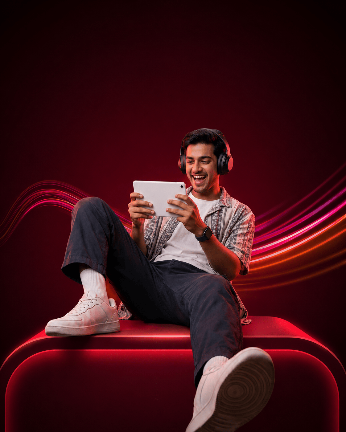 A young man playing games and using a tablet in a comfortable home setting.